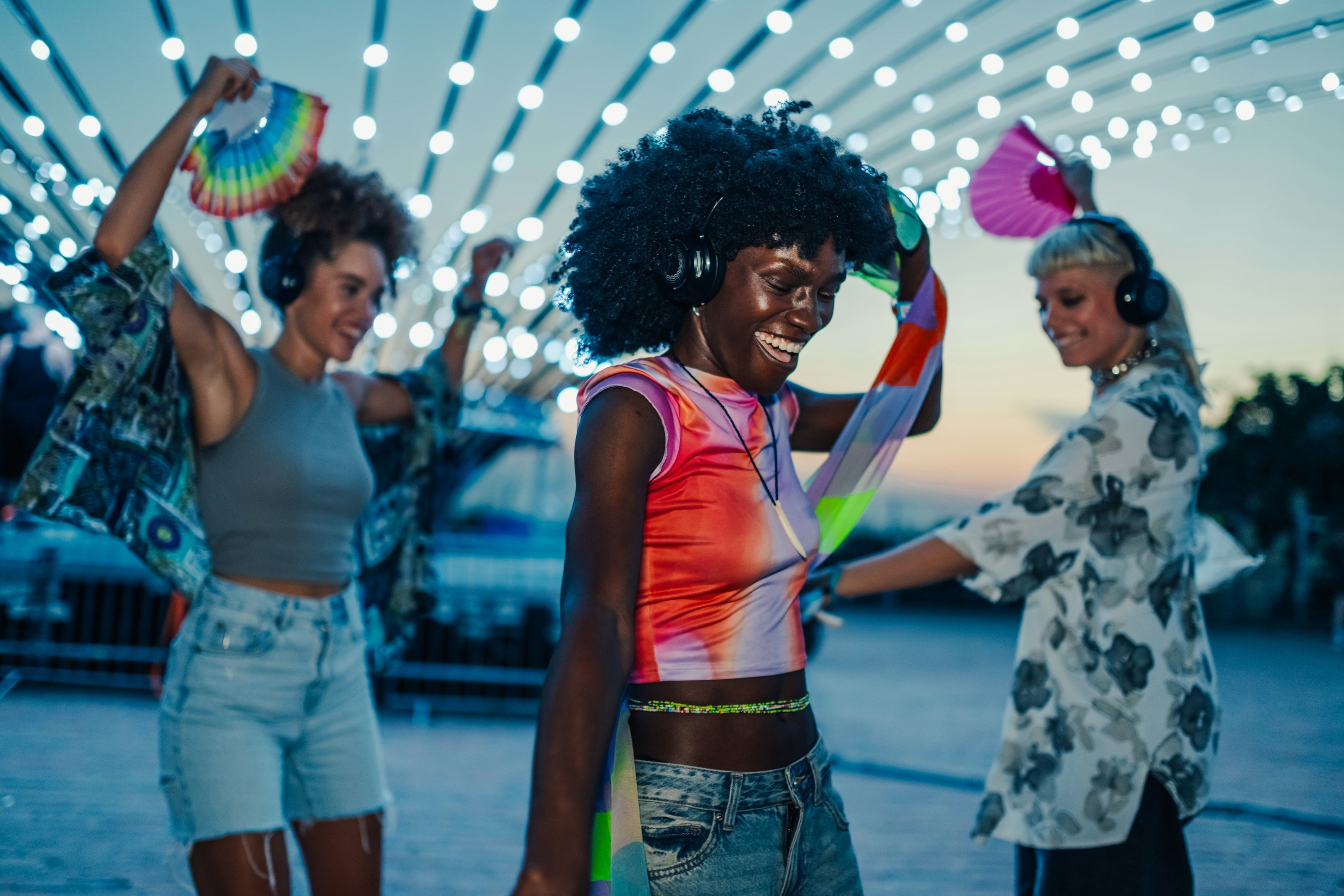 Friends dancing at an outdoor music festival